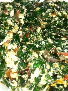 A picture of Eggs in vinespinach.
