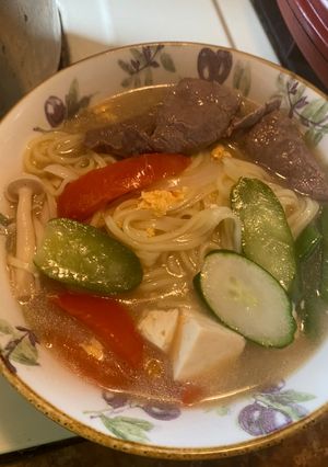 A picture of Beef Noodle Soup with Seasonal Vegetables and Fresh Mushrooms.