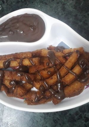 A picture of Fried bread sticks with homemade chocolate sauce.