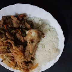 A picture of Fried Goat Meat Cabbages and Rice.