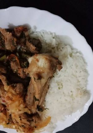 A picture of Fried Goat Meat Cabbages and Rice.