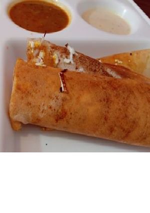 A picture of Masala dosa with sambhar.