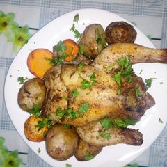 A picture of Baked Rosemary chicken with carrots and potatoes.