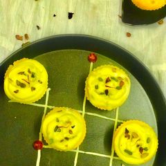 A picture of Kesar Almond Cup Cake with Shrikhand frosting.