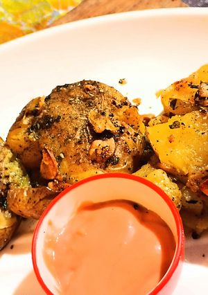 A picture of Chilli garlic smash baked potato.