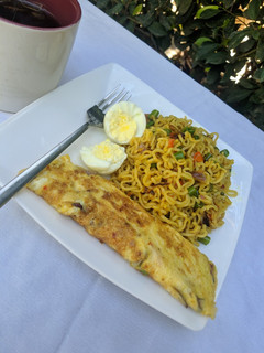 A picture of Stir fry noodles with egg omelette and boiled egg.