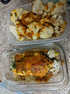 A picture of Baked cauliflower tilapia over quinoa with tomato curry sauce.