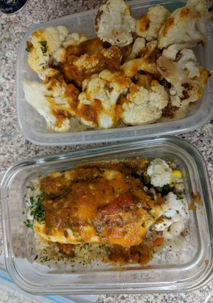 A picture of Baked cauliflower tilapia over quinoa with tomato curry sauce.