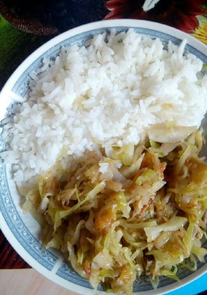 A picture of Rice served with fried cabbage.