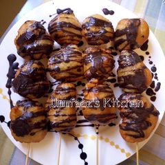 A picture of Puff puff with chocolate topping.