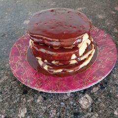 A picture of Fluffy pancakes with chocolate syrup.