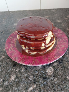 A picture of Fluffy pancakes with chocolate syrup.