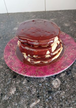 A picture of Fluffy pancakes with chocolate syrup.
