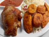 Boiled rice,fried plantain,fried turkey and tomato sauce