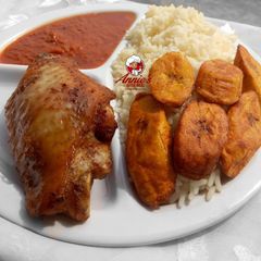 A picture of Boiled rice,fried plantain,fried turkey and tomato sauce.