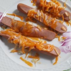A picture of Cheesy sliced hotdogs.