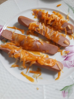 A picture of Cheesy sliced hotdogs.