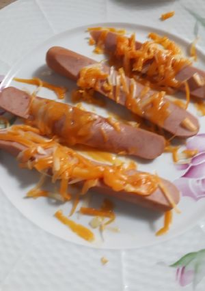 A picture of Cheesy sliced hotdogs.