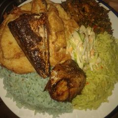 A picture of Jellof rice, yam n egg, cous low, friedfish and veg source.