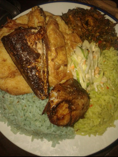 A picture of Jellof rice, yam n egg, cous low, friedfish and veg source.