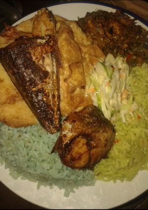 A picture of Jellof rice, yam n egg, cous low, friedfish and veg source.