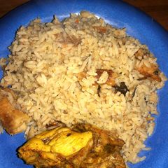 A picture of Coconut rice with dry fish and chicken.