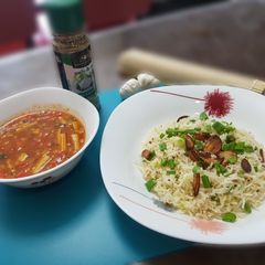 A picture of Burnt chilli garlic rice with baked beans gravy.