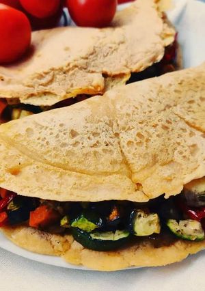 A picture of Lentil Crepes with Hummus and Roasted Vegetables.