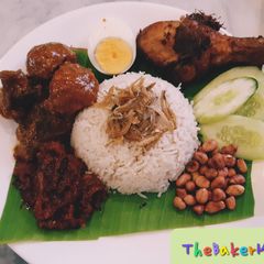 A picture of NasiLemak with Rendang and Lemongrass Friend Chicken and Sambal.