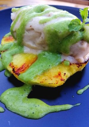 A picture of Grilled pineapple/ banana ice cream/lime and mint sauce.