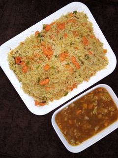 A picture of Egg fried rice with vegetable soup.