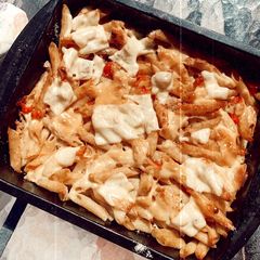 A picture of Pasta with tuna, tomato and parmesan.