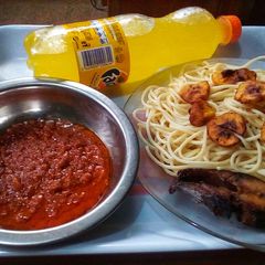 Signature fish sauce spaghetti and fried plantain A picture of Signature fish sauce spaghetti and fried plantain.