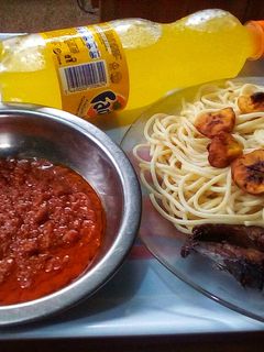 A picture of Signature fish sauce spaghetti and fried plantain.