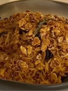 A picture of Rice with dry fruit.