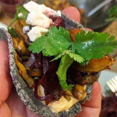 A picture of Veggie tacos with 'pulled' King Oyster mushroom + roast squash.