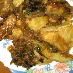 A picture of Potato Wedges and chicken stew.