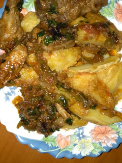 A picture of Potato Wedges and chicken stew.
