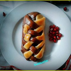 A picture of Banana and chocolate filled  double colored braided bread.