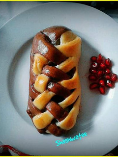 A picture of Banana and chocolate filled double colored braided bread.