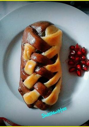 A picture of Banana and chocolate filled  double colored braided bread.