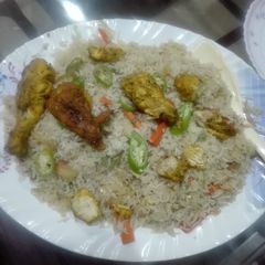 A picture of Steam chicken with vegetable fried rice.