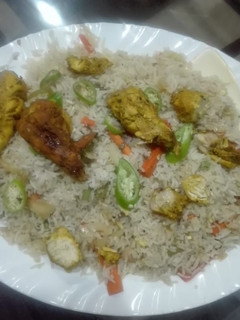 A picture of Steam chicken with vegetable fried rice.