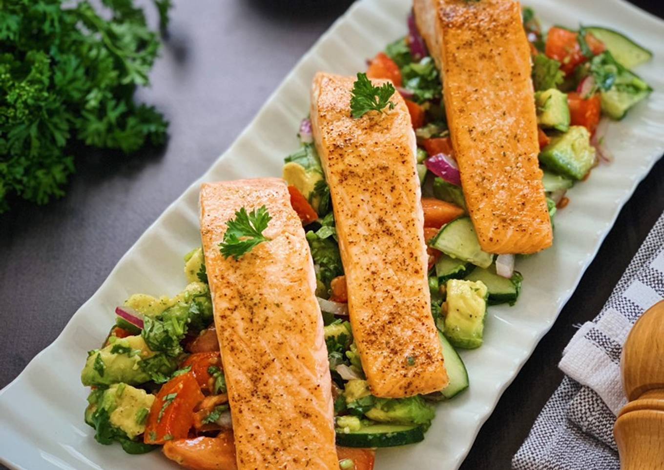Grilled salmon with avocado, tomato and cucumber salad
