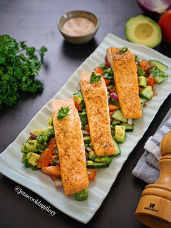 A picture of Pan Seared Salmon with Avocado Tomato Cucumber Salad.
