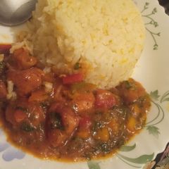 A picture of Chicken breast stew served with rice.