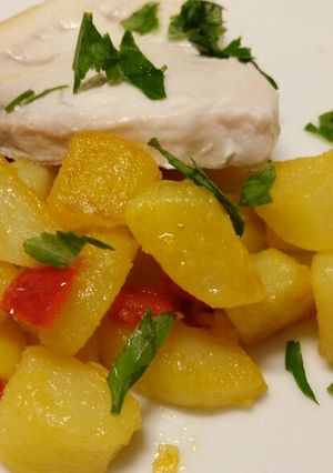 A picture of Pan fried swordfish with peppers and potatoes.