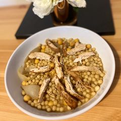 A picture of Moghrabieh - semolina dough with chicken.