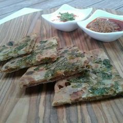 A picture of Dabaa style tandoori aloo parhath.