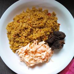 A picture of Jollof rice with coleslaw.